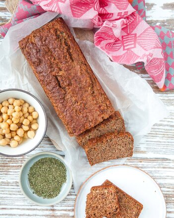 Auf dem Foto ist Gemüse Kraftbrot zu sehen. Daneben sind zwei Schüsselchen mit Kichererbsen und Gewürzen zu sehen. | © SONNENTOR