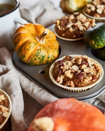 Auf dem Foto sind Pumpkin Spice Muffins zu sehen. Rundherum sind überall Kürbisse zu sehen. | © SONNENTOR